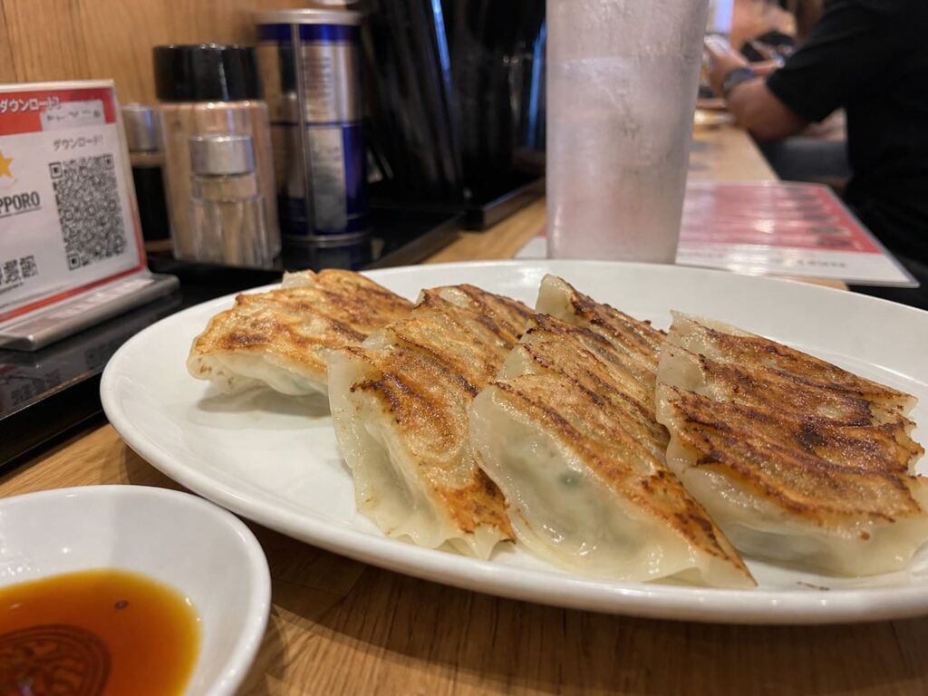 Kid-Friendly Foods to Try in Japan That Aren’t Sushi 12 Crispy pan-fried gyoza dumplings served with dipping sauce in a casual Japanese restaurant