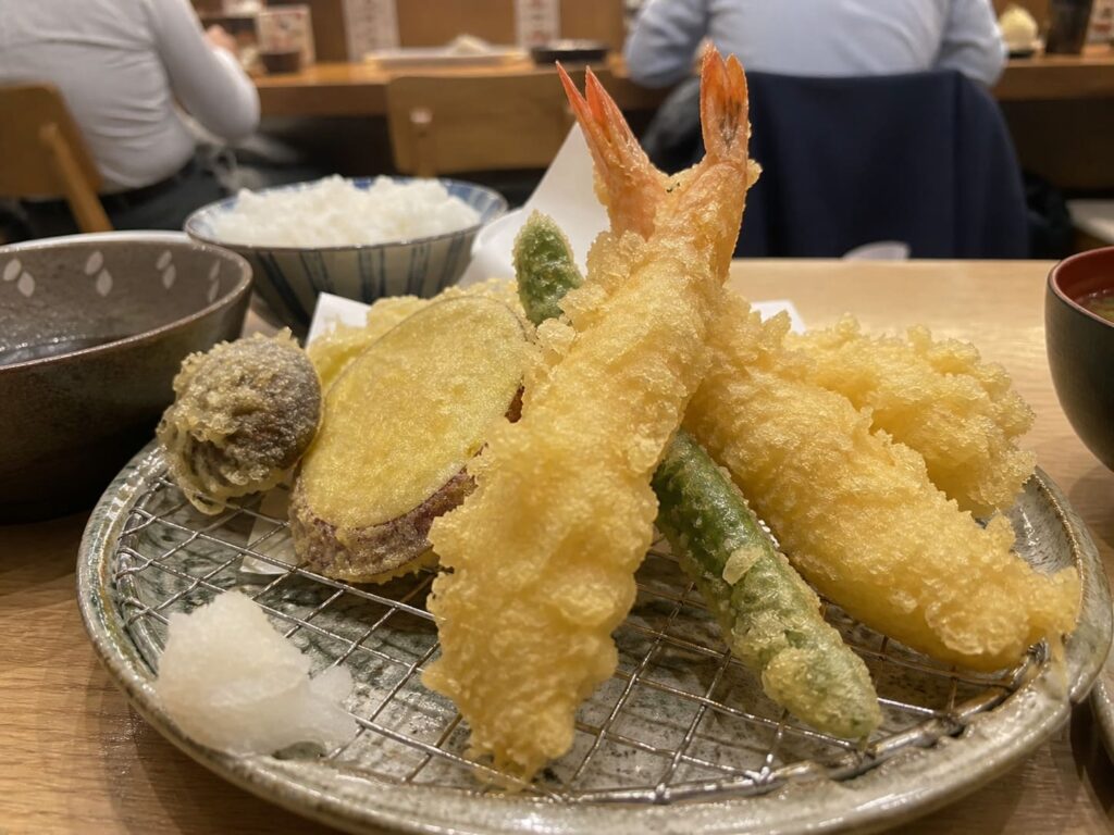 Kid-Friendly Foods to Try in Japan That Aren’t Sushi 13 Assorted shrimp and vegetable tempura served on a plate with rice in a Japanese restaurant