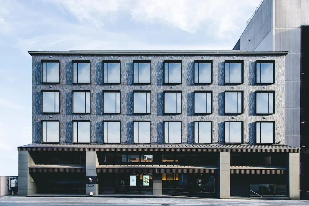 10 Best Muslim-Friendly Hotels (Halal) In Kyoto 10 Exterior facade of Dhawa Yura Kyoto hotel in Kyoto, Japan, featuring modern Japanese architecture and minimalist design