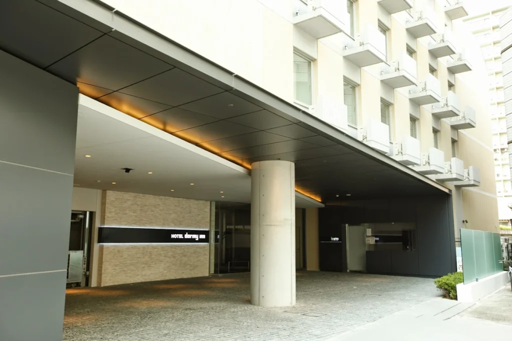 Entrance exterior of Dormy Inn Premium Shibuya Jingumae with modern minimalist design in Tokyo’s Shibuya district.