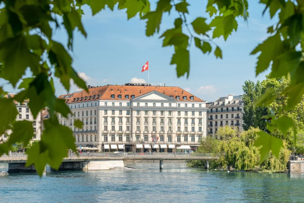 Four Seasons Hotel des Bergues Geneva beside the river in Geneva Switzerland surrounded by greenery