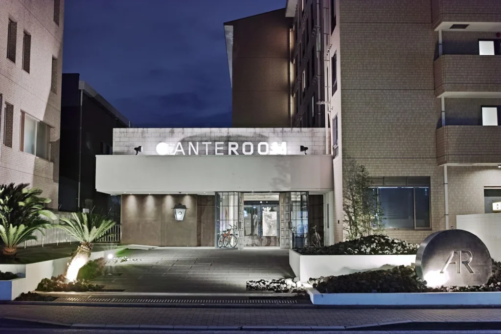 10 Best Hotels Near Fushimi Inari Shrine 7 Hotel Anteroom Kyoto entrance at night featuring contemporary architecture and stylish boutique design near Fushimi Inari Shrine.