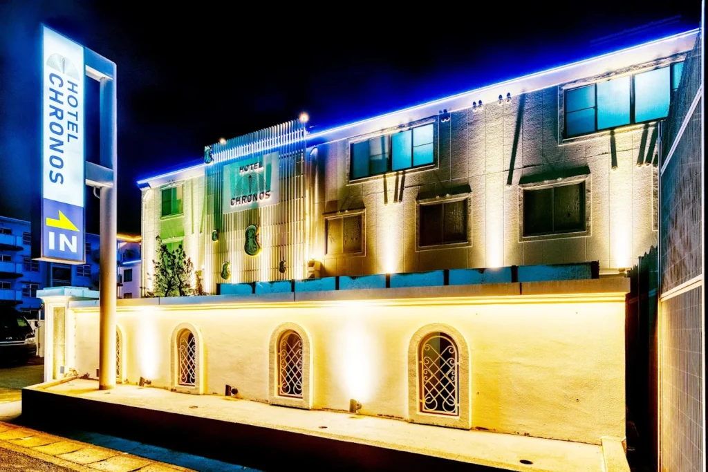 Exterior view of Hotel Chronos Kyoto illuminated at night with modern lighting, sleek architecture, and a stylish entrance in Kyoto, Japan.