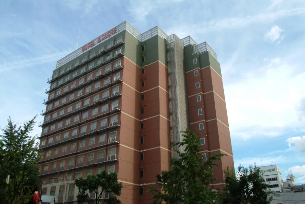 Exterior view of Hotel IL Cuore Namba near Namba Station in Osaka under a bright blue sky