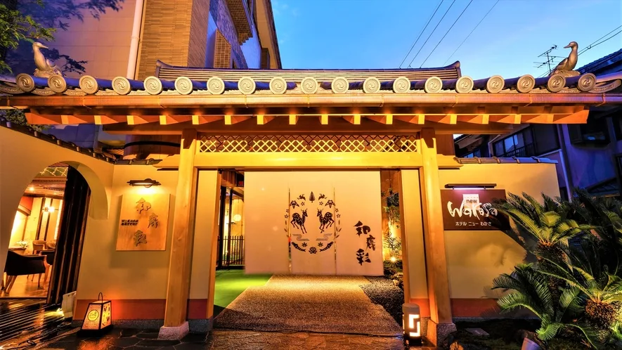 8 Best Hotels Near Nara Park: Luxury, Ryokan & Budget Stays 7 Traditional entrance of Hotel New Wakasa in Nara illuminated at night with classic Japanese ryokan architecture