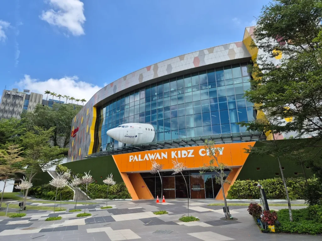Exterior view of Palawan Kidz City in Sentosa, Singapore, featuring the KidZania Singapore entrance and airplane display.