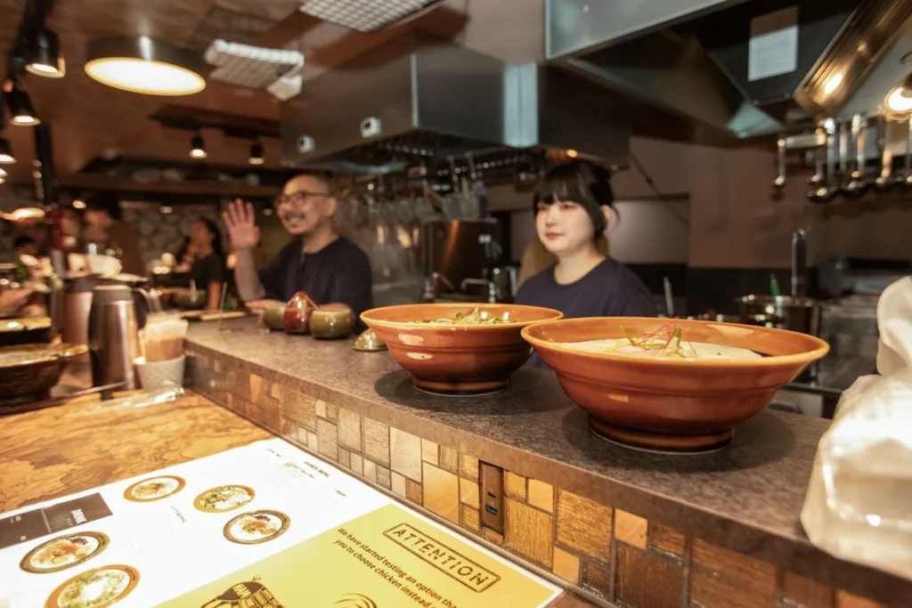 Halal Ramen in Japan: Where Muslim Travelers Can Find It 9 Interior of Kyoto Engine Ramen restaurant in Kyoto, Japan, serving halal-friendly ramen in an open kitchen setting