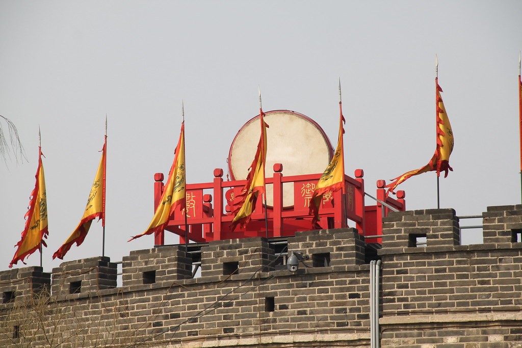 7 Underrated Cities in China Worth Visiting With Your Family 7 Traditional Chinese war drum and flags displayed on ancient city walls in Qufu, Shandong