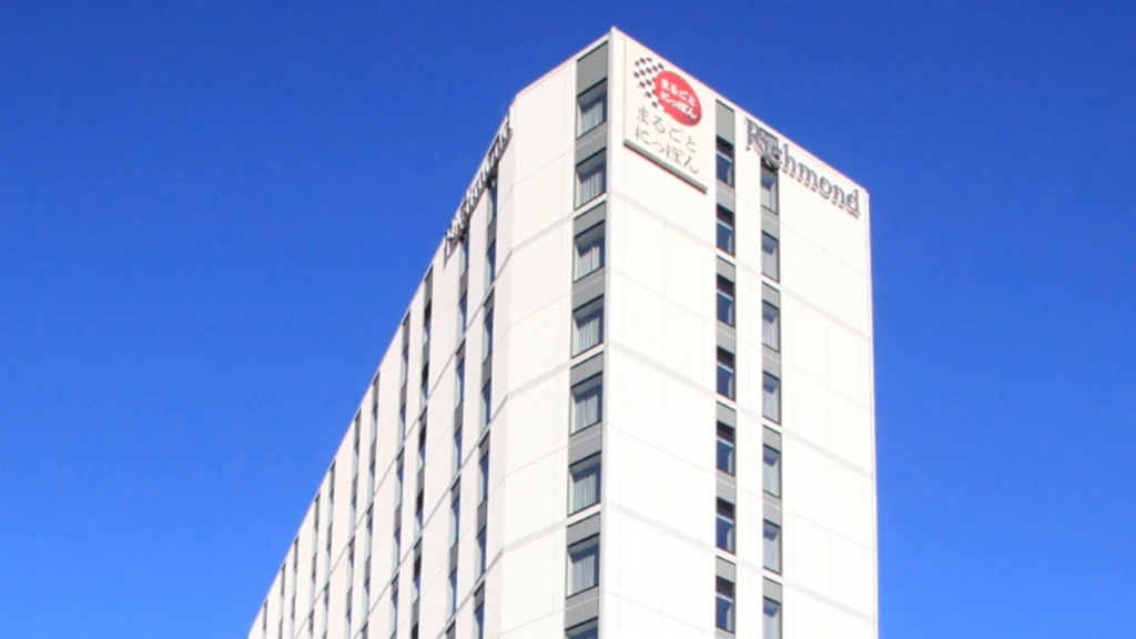 Exterior view of Richmond Hotel Premier Asakusa International in Tokyo under a bright blue sky, located near Asakusa Temple and popular shopping streets.