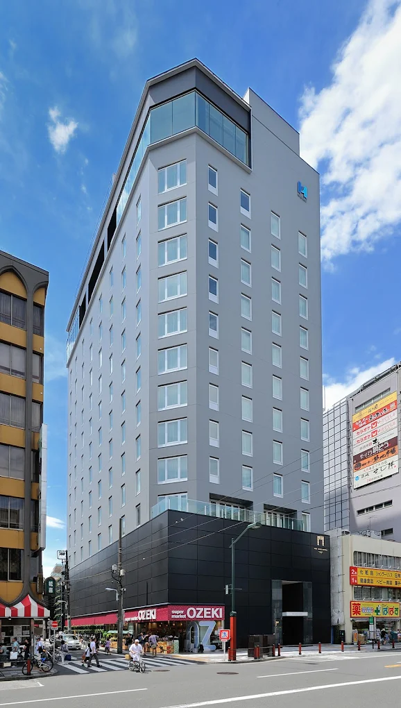 Exterior of The Gate Hotel Kaminarimon by Hulic in Asakusa, Tokyo, featuring a modern high-rise design near Asakusa Temple and Kaminarimon Gate.