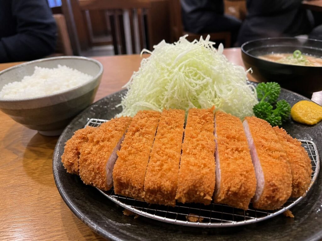 Kid-Friendly Foods to Try in Japan That Aren’t Sushi 9 Crispy tonkatsu pork cutlet sliced and served with cabbage, rice, and soup