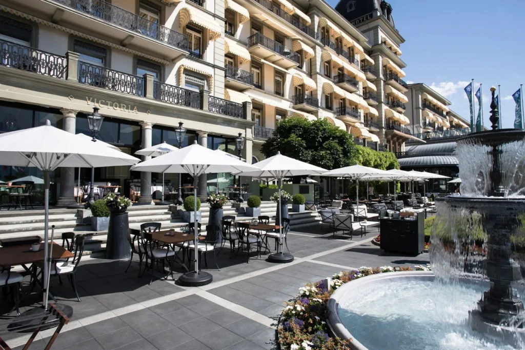 Victoria Jungfrau Grand Hotel & Spa exterior with outdoor terrace and fountain in Interlaken Switzerland