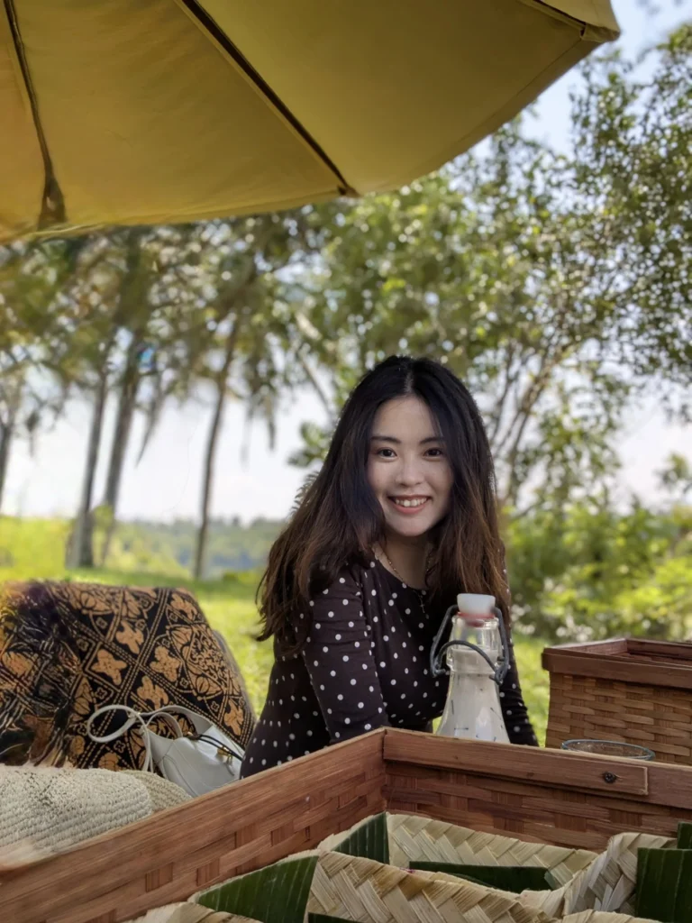 Amanjiwo Review: Is This Luxury Resort Near Borobudur Worth It? 40 Woman enjoying a riverside picnic experience at Amanjiwo resort near Borobudur in Central Java, Indonesia