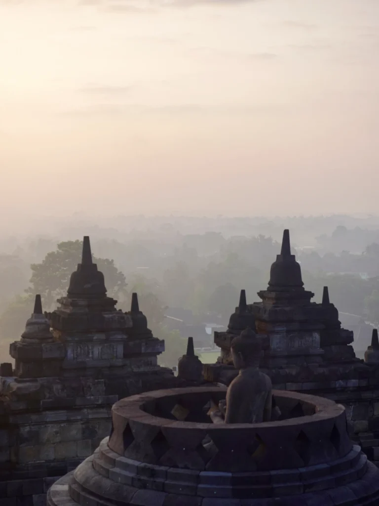 Amanjiwo Review: Is This Luxury Resort Near Borobudur Worth It? 32 Stone stupas and Buddha statue at Borobudur Temple during sunrise