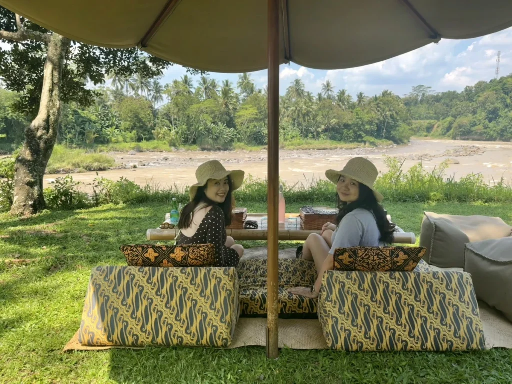 Amanjiwo Review: Is This Luxury Resort Near Borobudur Worth It? 37 Two women enjoying riverside picnic experience near Amanjiwo in Central Java