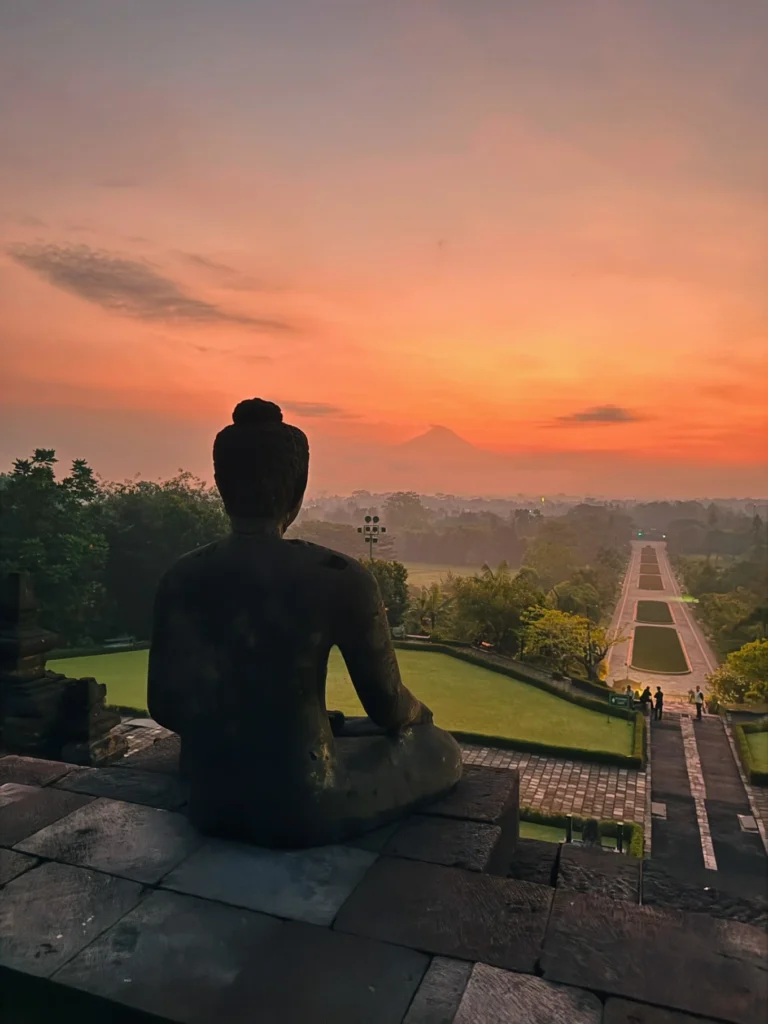 Amanjiwo Review: Is This Luxury Resort Near Borobudur Worth It? 43 Sunrise view from Borobudur Temple with Buddha statue overlooking Mount Merapi