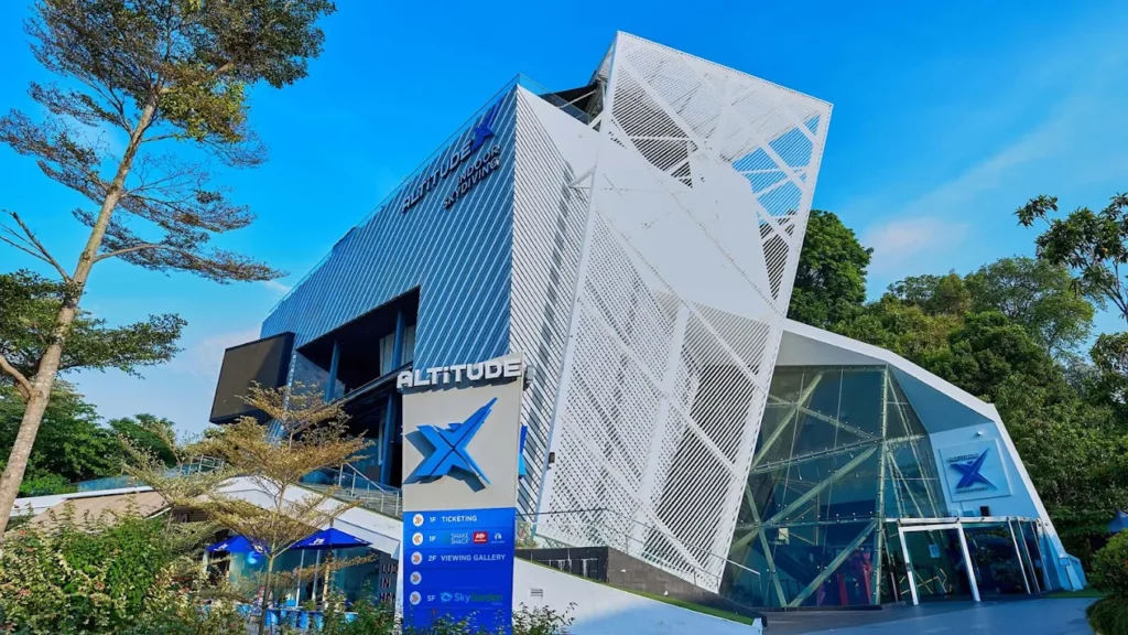 Exterior of iFly Singapore indoor skydiving facility in Sentosa under a bright blue sky.