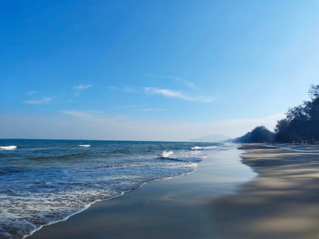 Hua Hin beach Thailand calm shoreline with gentle waves and clear blue sky family-friendly beach destination
