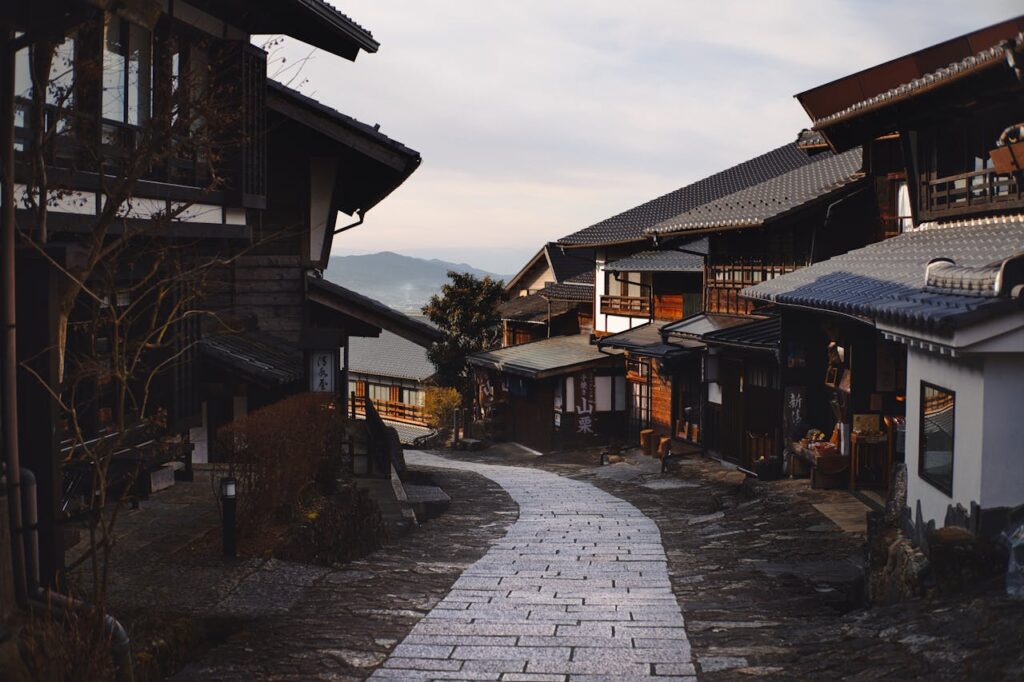 7 Best Hotels in Takayama Japan: Top Ryokans, Onsens & Family Stays 5 Traditional wooden street in historic Takayama Old Town with stone pathway and mountain views in Japan