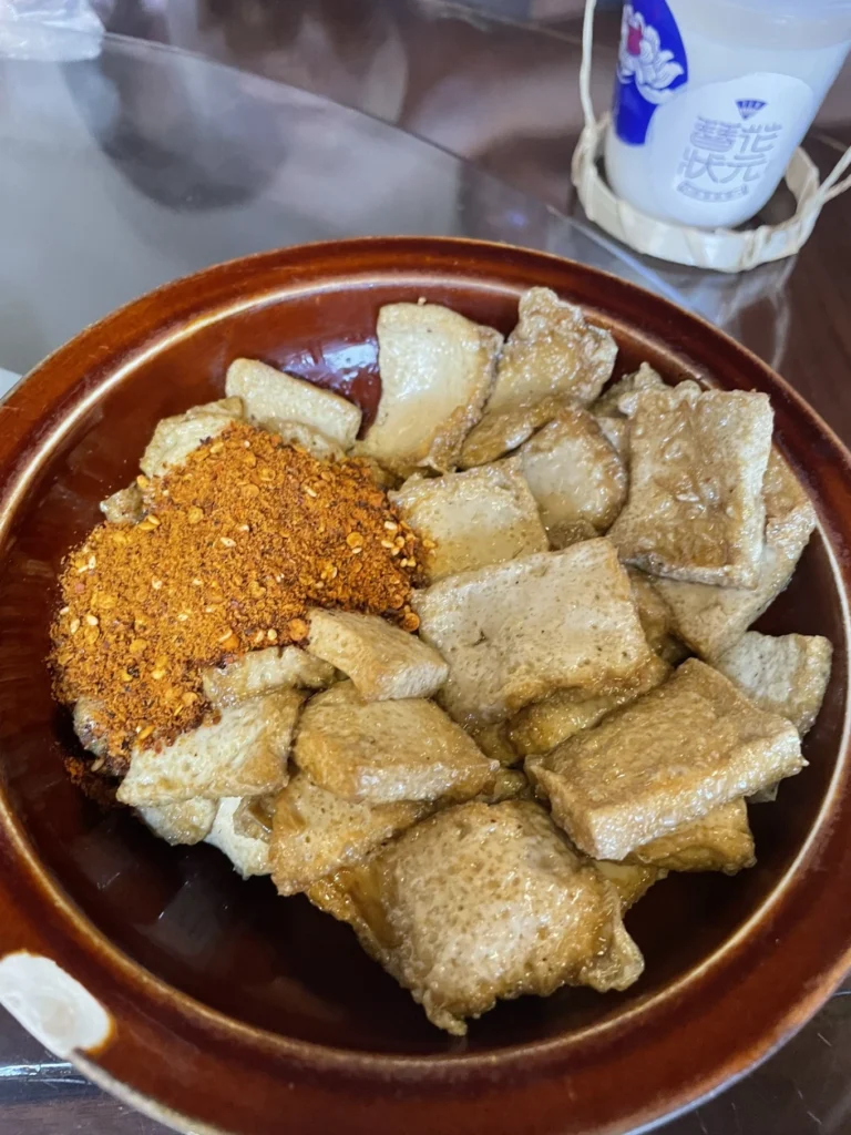 Qingyan Ancient Town Guide: Food, Night Views & Where to Stay 18 Local tofu dish with chili powder served at a restaurant in Qingyan Ancient Town.