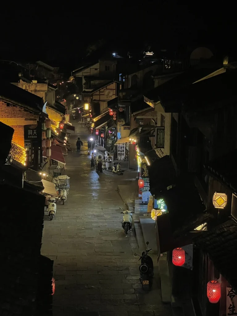Qingyan Ancient Town Guide: Food, Night Views & Where to Stay 15 Quiet night street scene with lanterns and traditional rooftops in Qingyan Ancient Town.