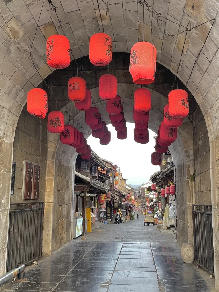 Qingyan Ancient Town Guide: Food, Night Views & Where to Stay 6 Red lanterns hanging inside the stone gate entrance of Qingyan Ancient Town.