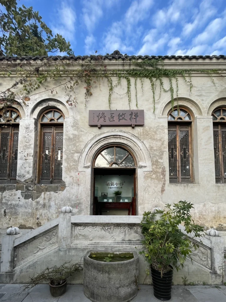Qingyan Ancient Town Guide: Food, Night Views & Where to Stay 9 Historic stone building with arched windows and vines in Qingyan Ancient Town.