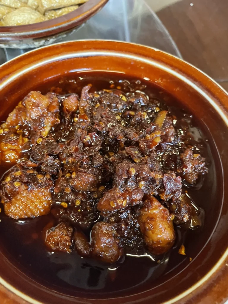 Qingyan Ancient Town Guide: Food, Night Views & Where to Stay 17 Spicy Guizhou-style chili meat dish served in Qingyan Ancient Town.