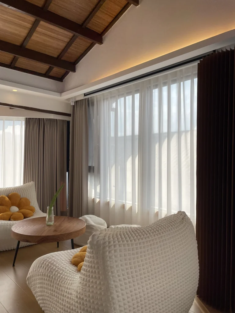 Qishe Inn Review: Cozy Family Stay Near Qingyan Ancient Town 7 Modern minimalist seating area with floor-to-ceiling curtains at Qishe Inn