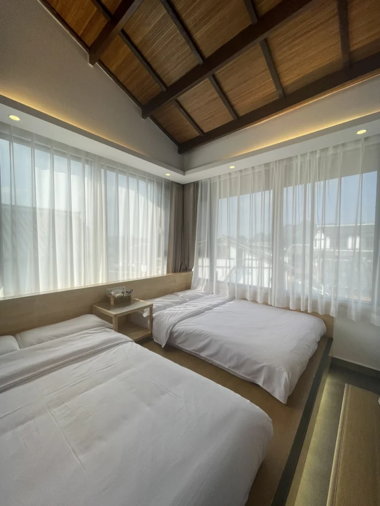 Qishe Inn Review: Cozy Family Stay Near Qingyan Ancient Town 8 Family bedroom with large beds and panoramic windows at Qishe Inn Qingyan Ancient Town