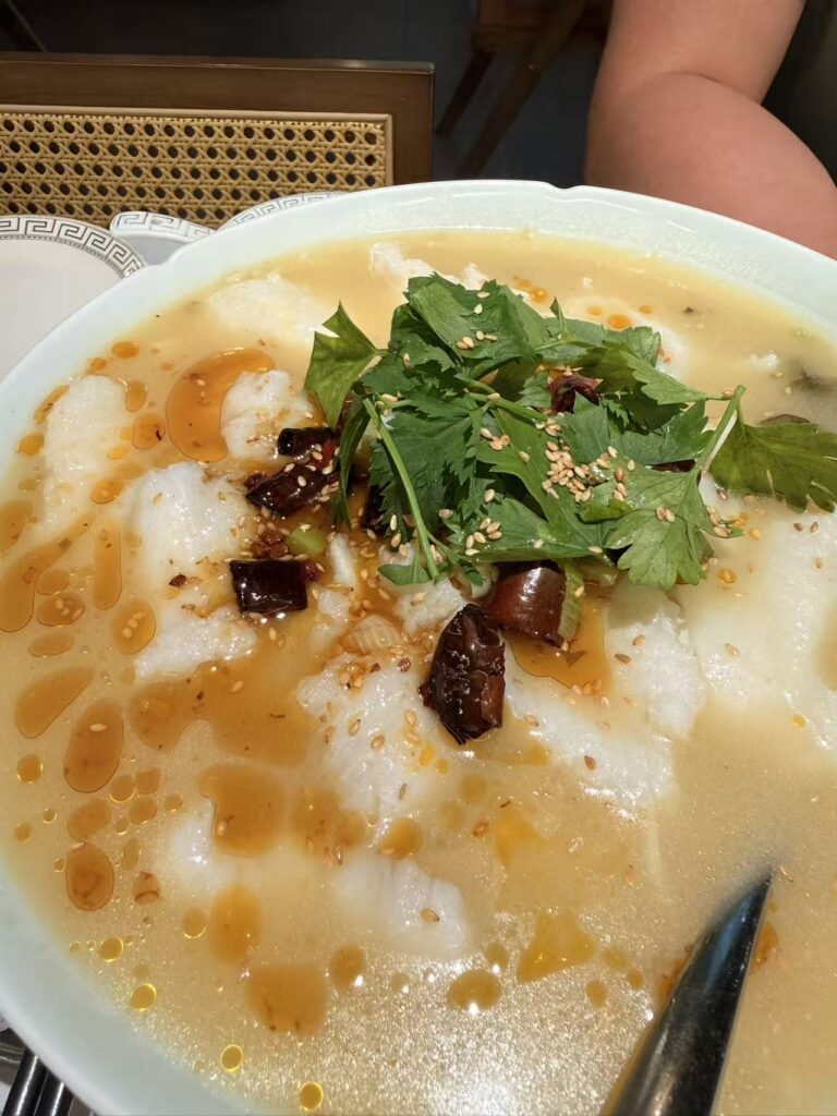 Suan Cai Yu sauerkraut fish soup with chilli oil and coriander at Chengdu Bowl Changi Airport