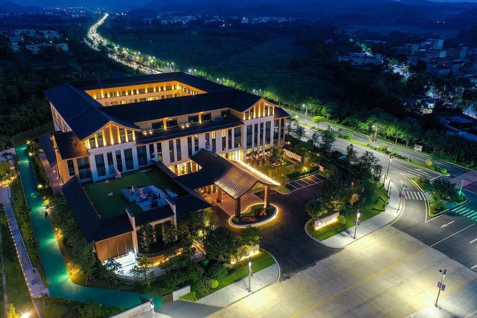 Dali Ancient Luchun Hotel illuminated at night with traditional Chinese-inspired architecture and landscaped grounds in Dali, Yunnan
