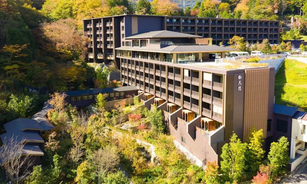 Hakone Kowakien Tenyu resort nestled among forested hills in Hakone, featuring modern architecture, landscaped gardens, and luxury onsen accommodations.