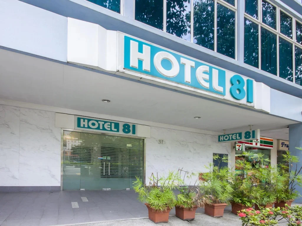 Exterior entrance of Hotel 81 Bugis in Singapore, featuring the hotel signage above the main entrance and potted plants outside the building.