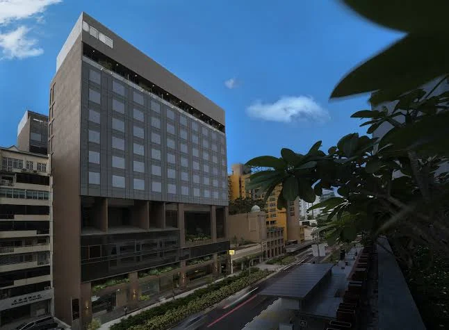Exterior view of Hotel Mi Bencoolen in Singapore, featuring the modern hotel building along Bencoolen Street with surrounding city architecture.