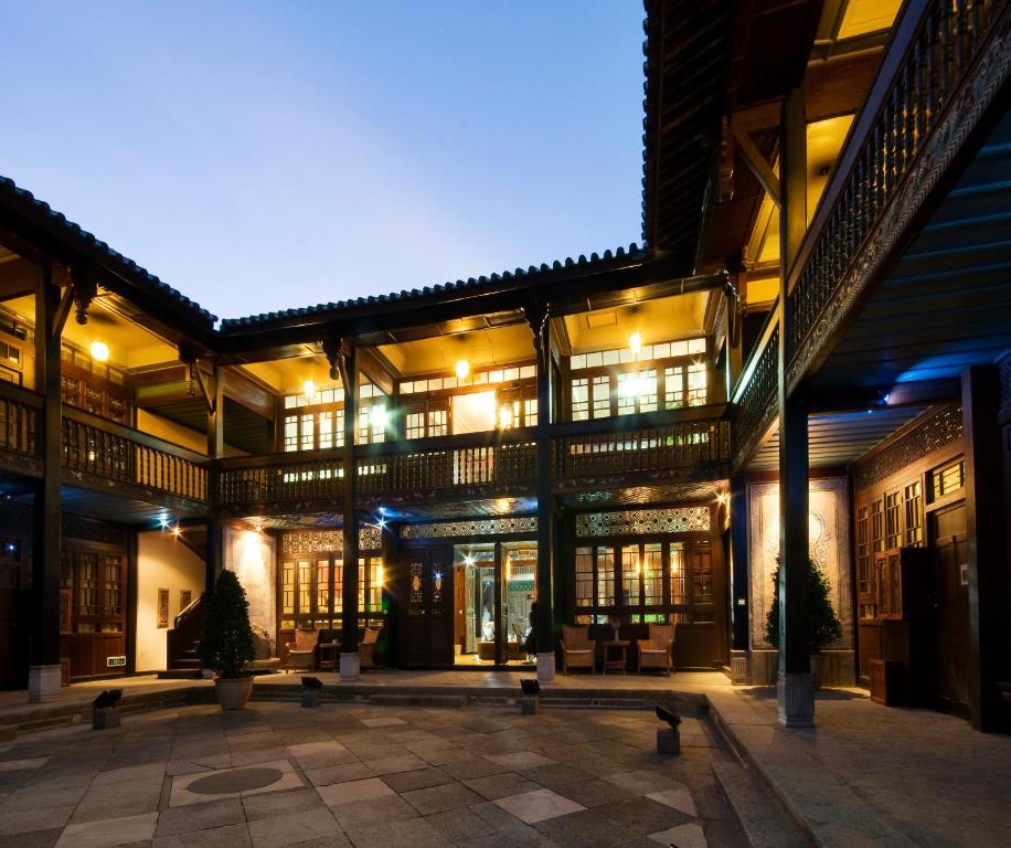 The Linden Centre Xizhou traditional Bai-style courtyard hotel illuminated at night in Xizhou Ancient Town, Dali, Yunnan