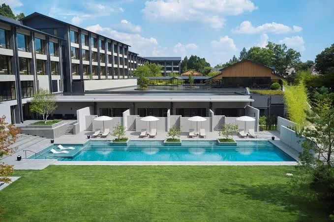 Outdoor swimming pool at Roku Kyoto, LXR Hotels & Resorts, featuring modern luxury accommodations, landscaped gardens, and private poolside cabanas in Kyoto, Japan