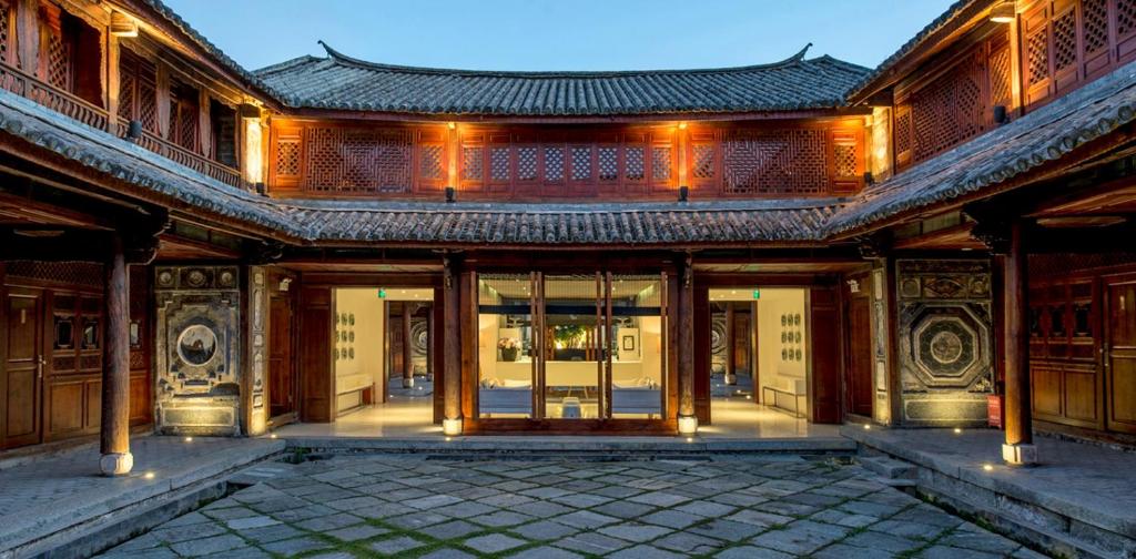 Sky Valley Heritage Boutique Hotel traditional Bai-style courtyard illuminated at night in Dali, featuring restored heritage architecture and elegant cultural design