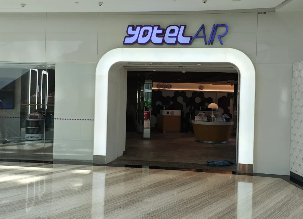 Entrance to YOTELAIR Singapore Changi Airport inside Jewel Changi Airport, featuring the modern hotel lobby and futuristic branding.