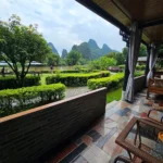 Yangshuo Mountain Retreat terrace overlooking the Yulong River and karst mountains in Yangshuo, China