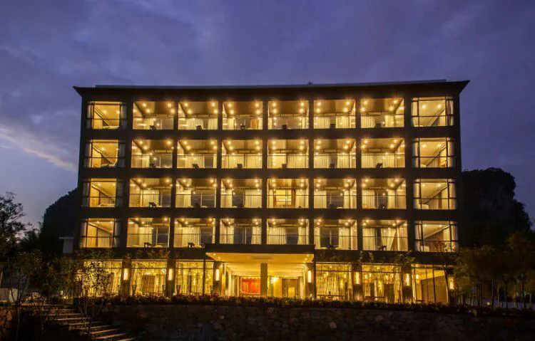 Yuyuan Jingshe hotel illuminated at night in the Yangshuo countryside, China