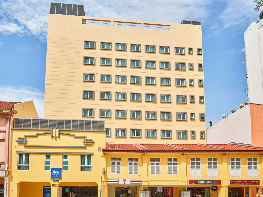Exterior view of ibis budget Singapore Selegie, showing the hotel building along Selegie Road with heritage shophouses and nearby commercial establishments.