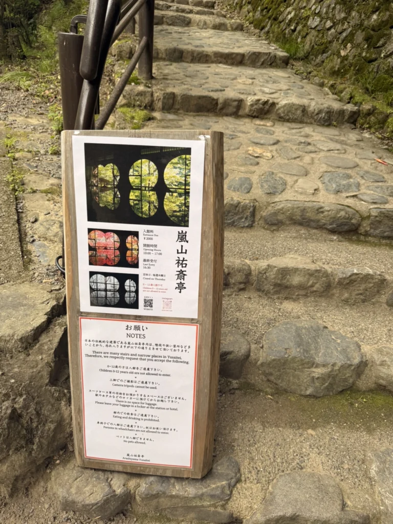 Information sign at the entrance of Arashiyama Yusai-tei in Kyoto showing admission fee and opening hour