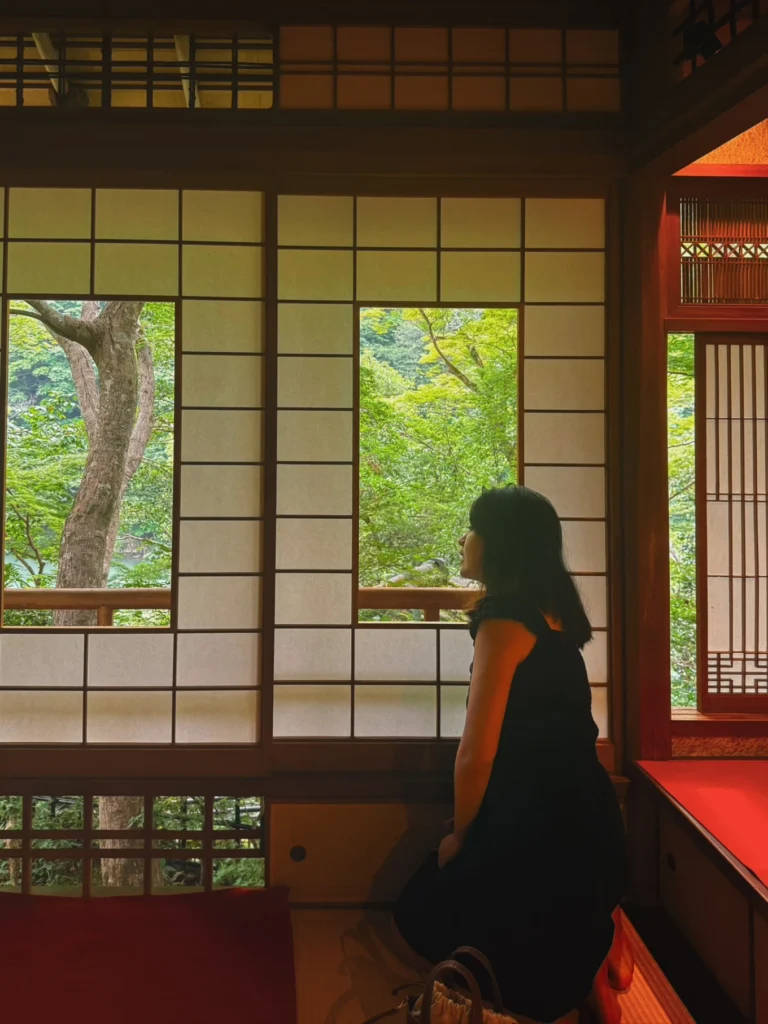 Traditional tatami room with shoji windows overlooking the garden at Arashiyama Yusai-tei