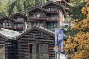 CERVO Mountain Resort wooden alpine chalets surrounded by larch trees in Zermatt, Switzerland