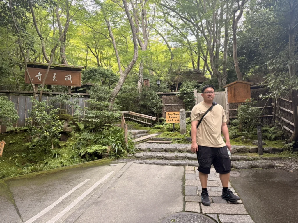 Gioji Temple Kyoto: Is the Moss Garden Worth Visiting? 5 Visitor standing outside the moss-covered entrance to Gioji Temple in Arashiyama, Kyoto