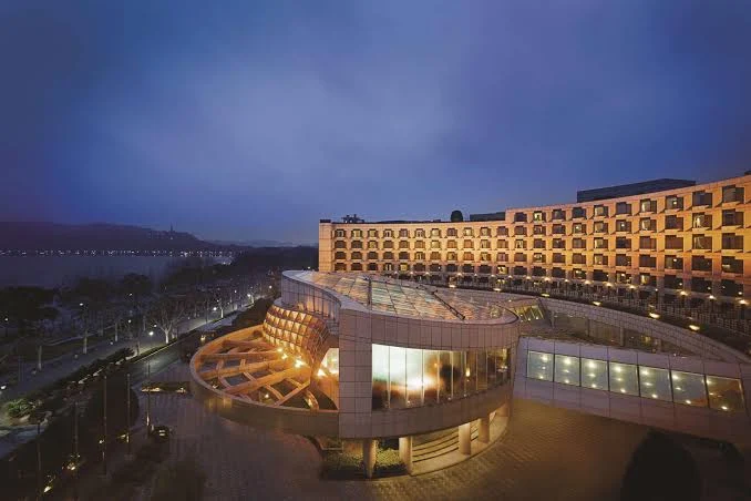 Exterior view of Grand Hyatt Hangzhou overlooking West Lake at dusk