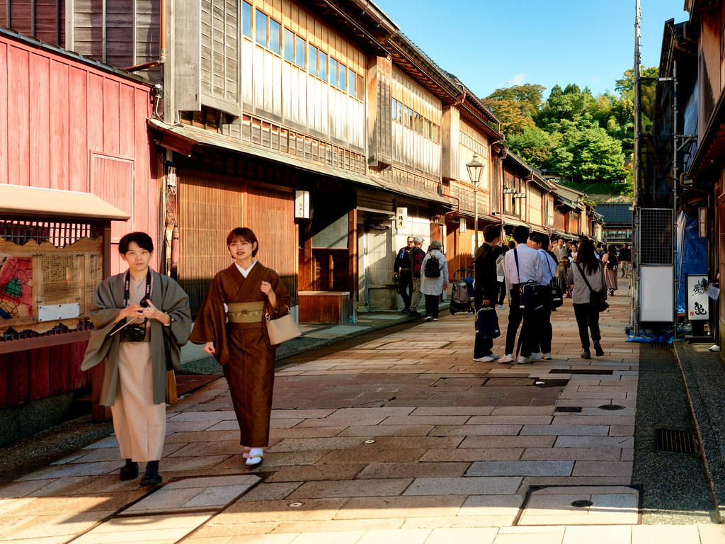 Visitors wearing traditional kimono stroll through the historic Higashi Chaya District in Kanazawa, Japan, one of the best areas to stay for culture, sightseeing, and traditional ryokan experiences.