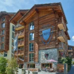 Hotel Firefly in Zermatt with traditional wooden chalet architecture and the Matterhorn in the background