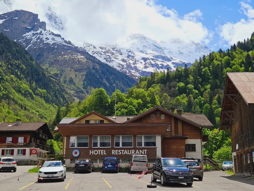 Exterior of Hotel Stechelberg in Lauterbrunnen Valley, Switzerland, with traditional wooden chalet architecture, mountain scenery, and convenient access to the Schilthorn cable car.